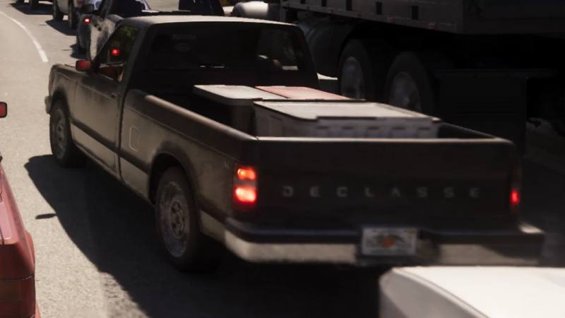 Un pick-up Declasse Walton L35 Stock de couleur sombre, avec une carrosserie anguleuse et robuste, idéal pour le hors-piste.